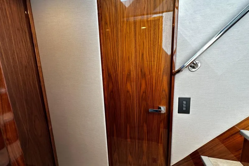  Yacht Photos Pics Interior of 2023 Riviera 465 SUV featuring sleek wood paneling and modern design elements.