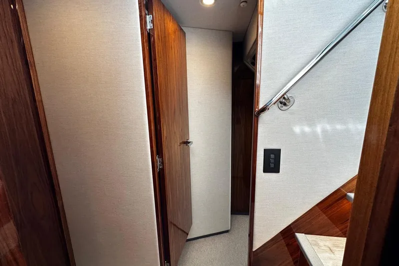  Yacht Photos Pics Interior hallway of 2023 Riviera 465 SUV yacht with wooden doors and modern design.