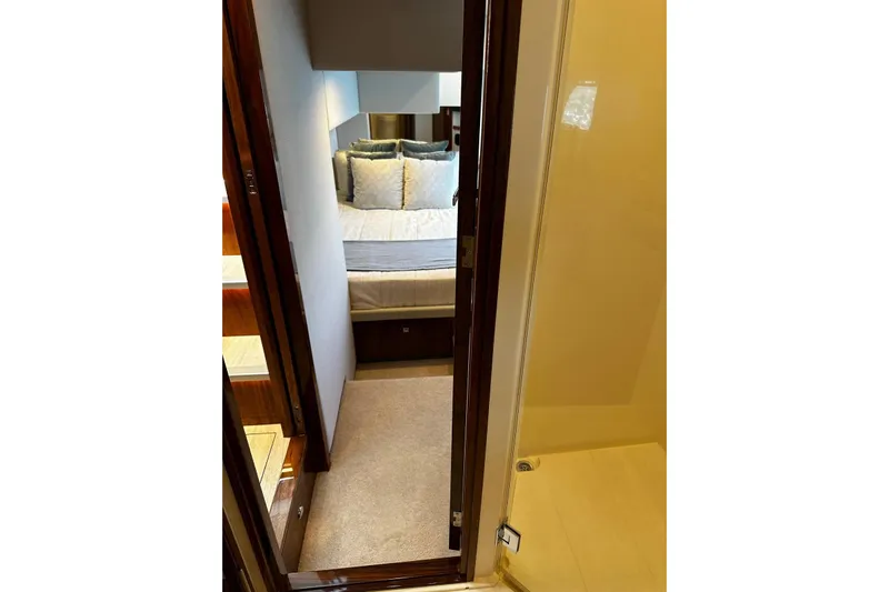  Yacht Photos Pics Interior view of 2023 Riviera 465 SUV bedroom with cozy bedding and modern design.