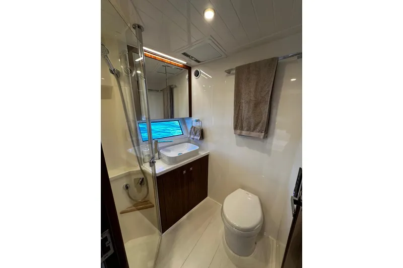  Yacht Photos Pics Luxurious bathroom in 2023 Riviera 465 SUV yacht with modern fixtures and ocean view.