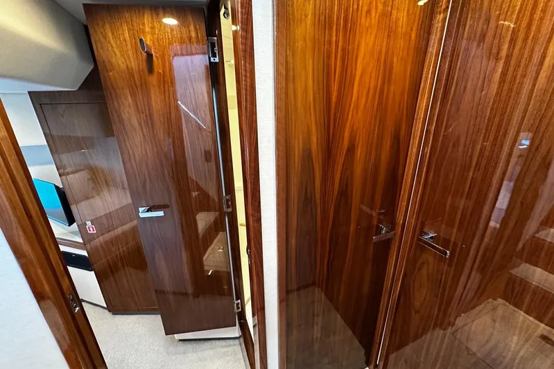  Yacht Photos Pics Luxurious wooden interior of 2023 Riviera 465 SUV yacht, featuring sleek cabinetry and modern design.