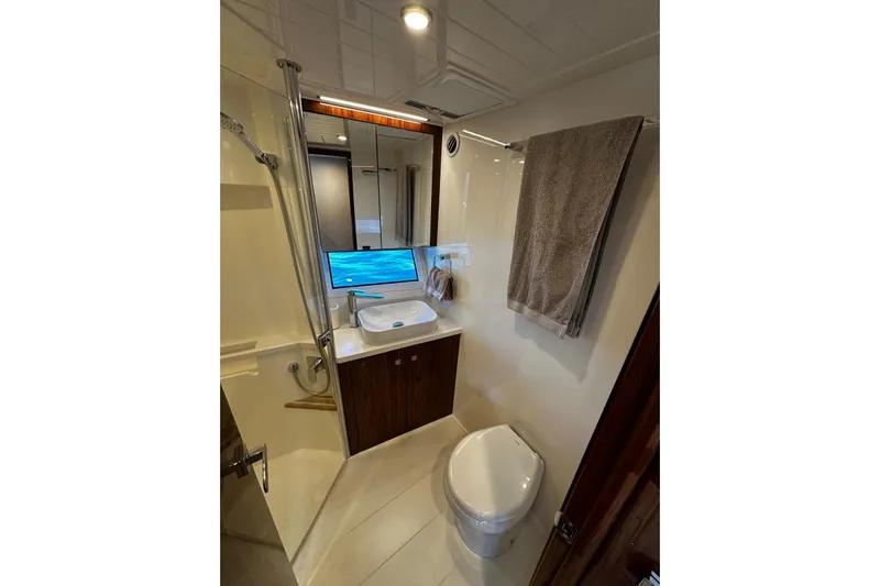  Yacht Photos Pics Luxurious bathroom in 2023 Riviera 465 SUV yacht with modern fixtures and ocean view.