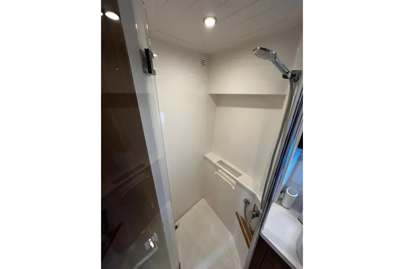  Yacht Photos Pics Modern shower area in 2023 Riviera 465 SUV yacht, featuring sleek design and fixtures.