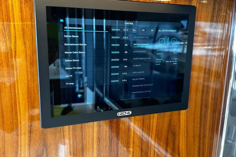  Yacht Photos Pics Touchscreen control panel on 2023 Riviera 465 SUV yacht, displaying entertainment and system settings.
