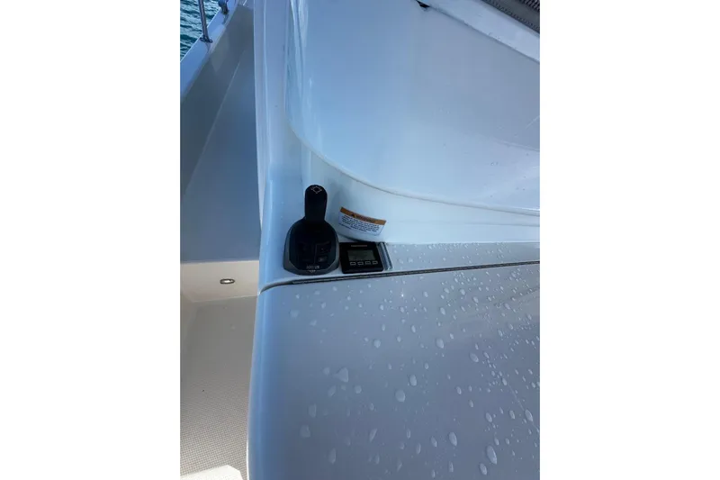  Yacht Photos Pics Control panel on 2023 Riviera 465 SUV yacht, featuring sleek design and water droplets.