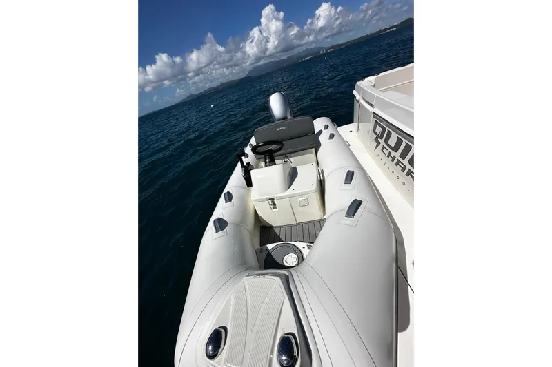  Yacht Photos Pics 2023 Riviera 465 SUV with inflatable boat on open sea under blue sky.