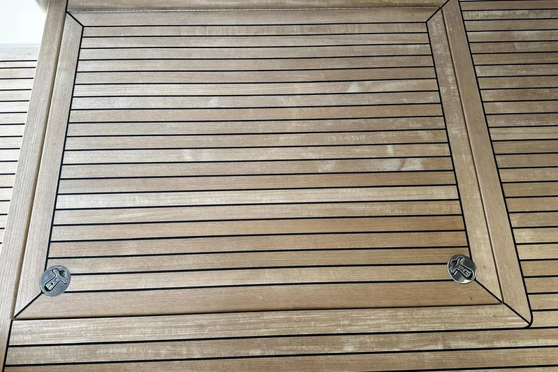  Yacht Photos Pics Teak deck of 2023 Riviera 465 SUV yacht, featuring sleek, parallel lines and metal fixtures.