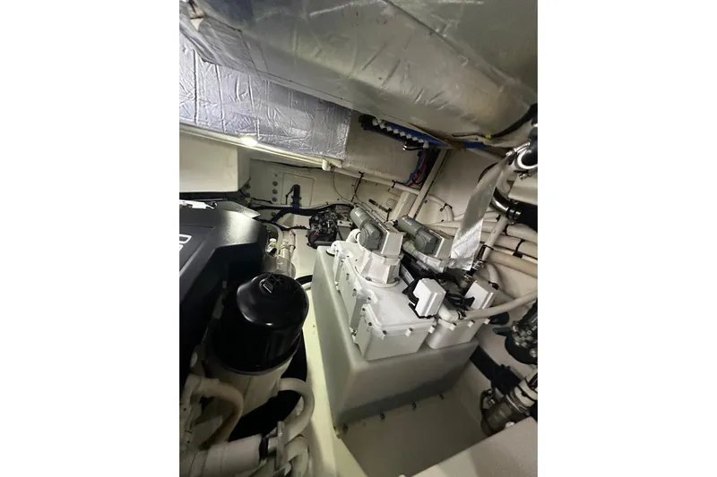  Yacht Photos Pics Engine room of 2023 Riviera 465 SUV yacht, showcasing mechanical components and wiring.