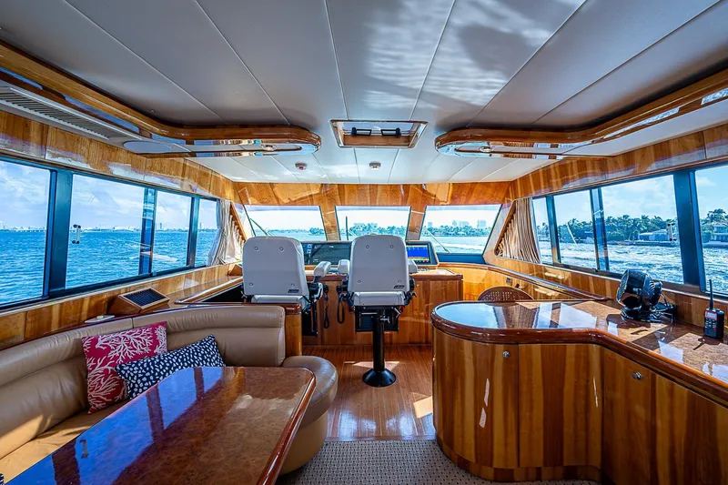 The Usual Yacht Photos Pics Luxurious interior of 2000 Horizon 82 yacht with panoramic windows and elegant wood finishes.
