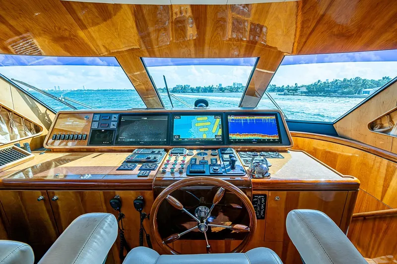 The Usual Yacht Photos Pics Luxurious Horizon 82 yacht helm with advanced navigation systems, wooden finish, and ocean view.