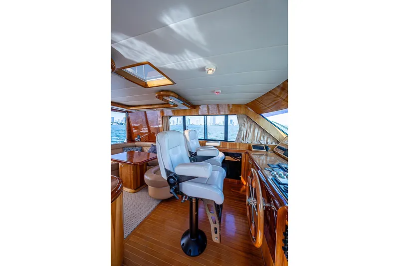 The Usual Yacht Photos Pics Luxurious interior of 2000 Horizon 82 yacht with plush seating and wooden finishes.