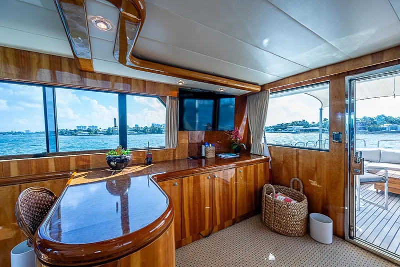 The Usual Yacht Photos Pics Luxurious interior of 2000 Horizon 82 yacht with polished wood and waterfront views.