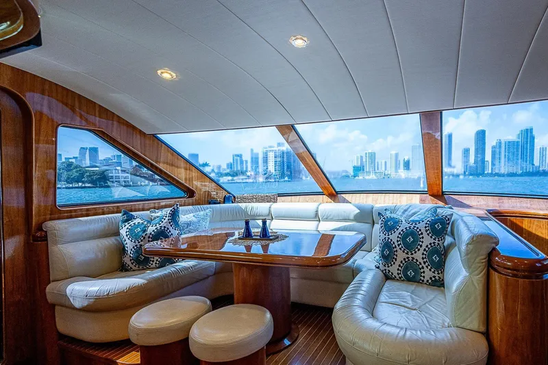 The Usual Yacht Photos Pics Luxurious Horizon 82 yacht interior with city skyline view, featuring plush seating and elegant wood finishes.