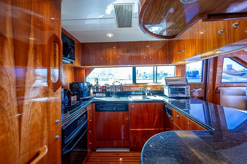 The Usual Yacht Photos Pics Luxurious yacht kitchen with wooden cabinetry and modern appliances, Horizon 82, year 2000.