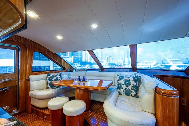 The Usual Yacht Photos Pics Luxurious Horizon 82 yacht interior with plush seating, wooden accents, and scenic window views.