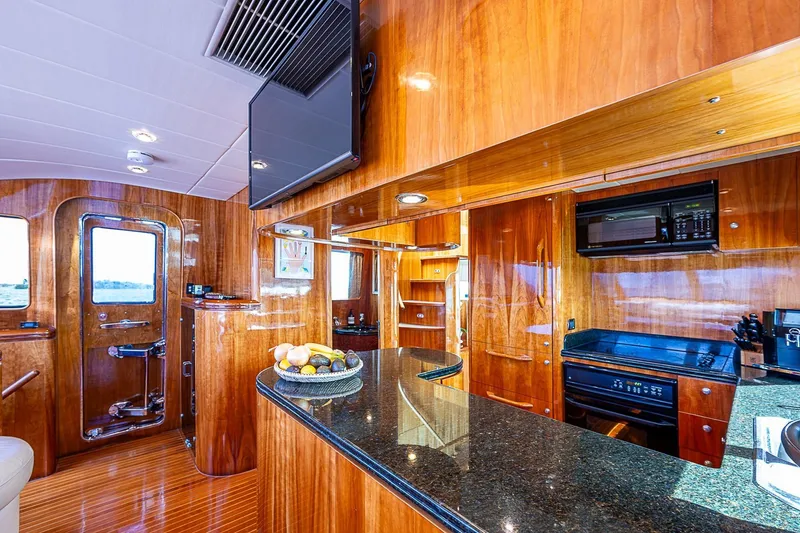 The Usual Yacht Photos Pics Luxurious yacht kitchen interior with wooden cabinetry, granite countertops, and modern appliances, Horizon 82, 2000.