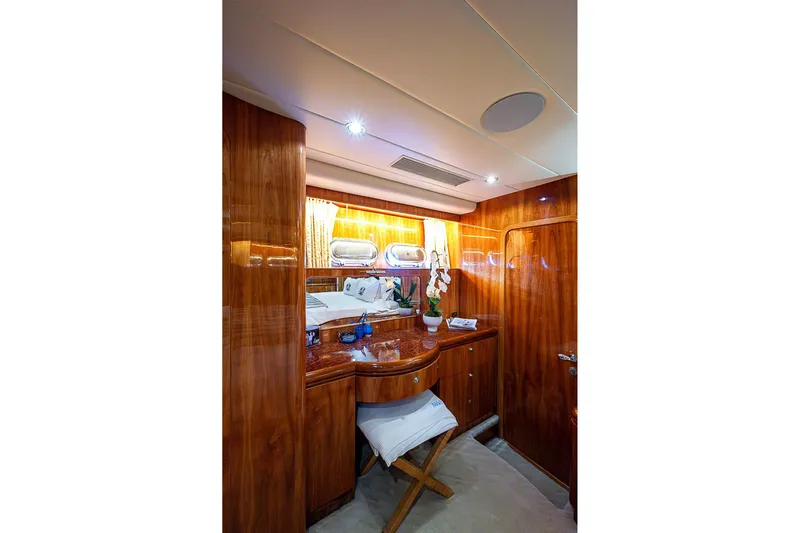The Usual Yacht Photos Pics Luxurious wooden interior of 2000 Horizon 82 yacht cabin with elegant decor.