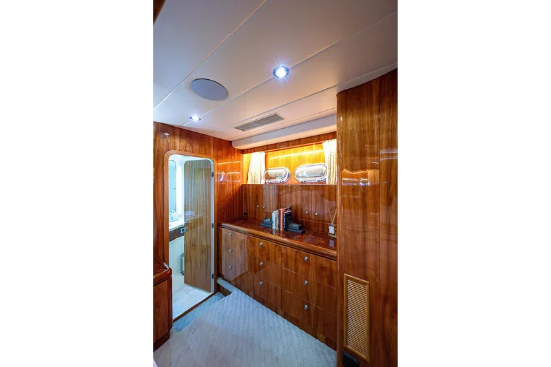 The Usual Yacht Photos Pics Luxurious wooden interior of 2000 Horizon 82 yacht with elegant cabinetry and lighting.