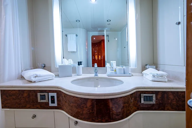 The Usual Yacht Photos Pics Luxurious yacht bathroom with elegant sink, mirror, and toiletries, Horizon 82, 2000 model.