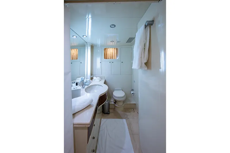 The Usual Yacht Photos Pics Luxurious bathroom in 2000 Horizon 82 yacht with modern fixtures and elegant design.