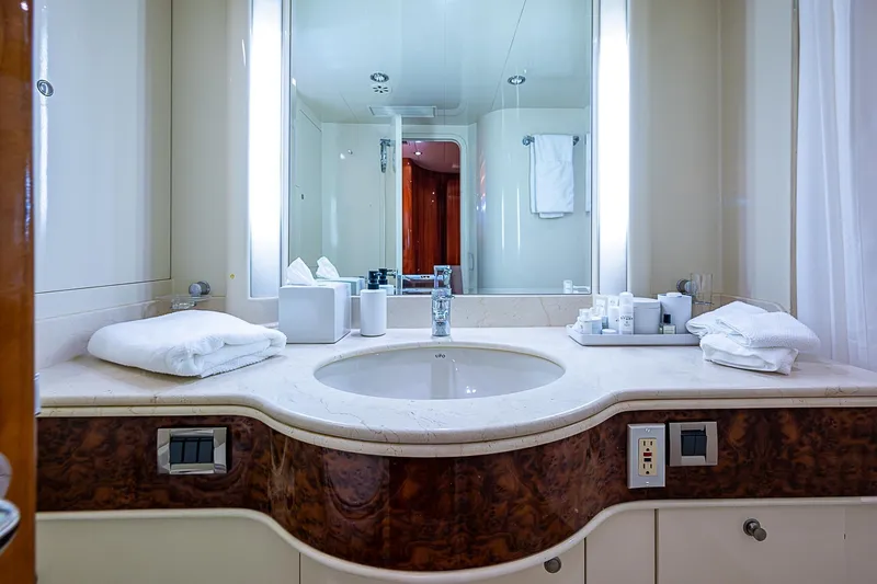 The Usual Yacht Photos Pics Luxurious yacht bathroom with marble countertop, mirror, and toiletries on Horizon 82, year 2000.