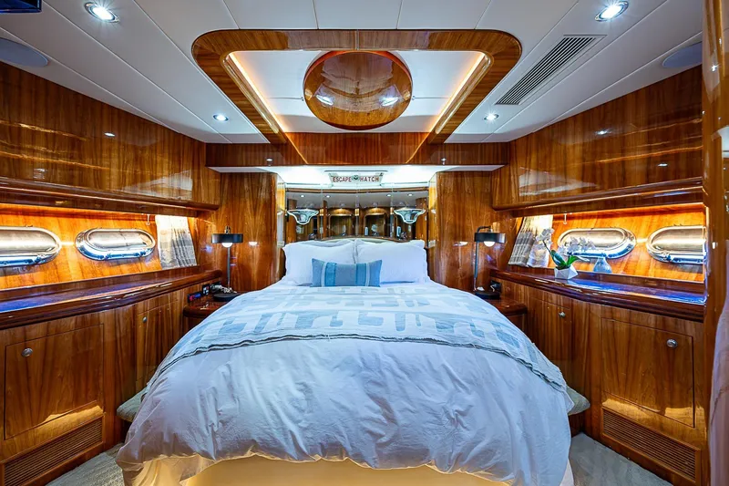 The Usual Yacht Photos Pics Luxurious bedroom interior of 2000 Horizon 82 yacht with wood paneling and elegant lighting.