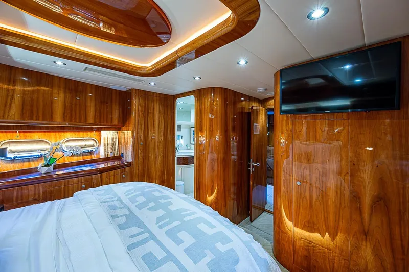 The Usual Yacht Photos Pics Luxurious cabin interior of 2000 Horizon 82 yacht with wood paneling and modern amenities.