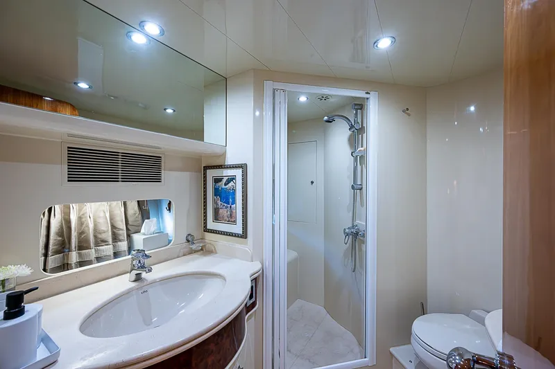 The Usual Yacht Photos Pics Luxurious bathroom in 2000 Horizon 82 yacht with shower, sink, and modern lighting.