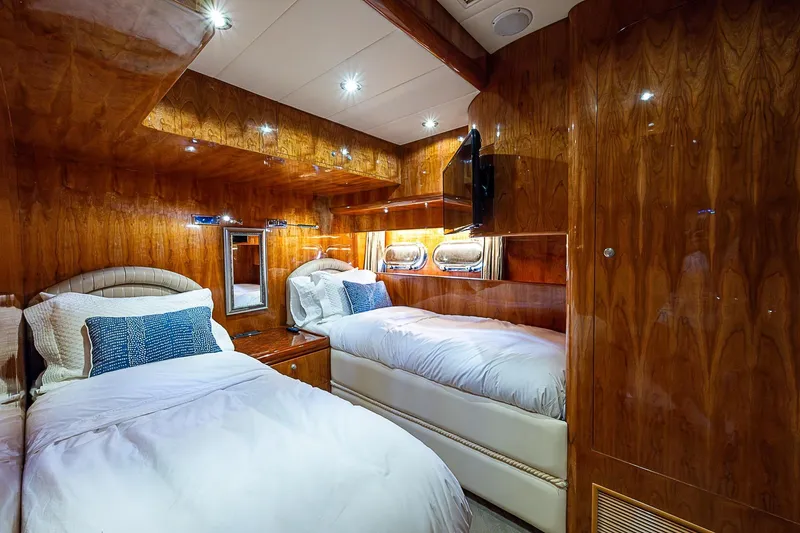 The Usual Yacht Photos Pics Luxurious twin cabin interior on 2000 Horizon 82 yacht with wood paneling and modern lighting.