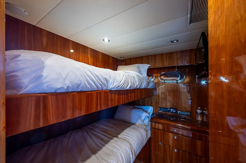 The Usual Yacht Photos Pics Luxurious wooden cabin with bunk beds in 2000 Horizon 82 yacht interior.