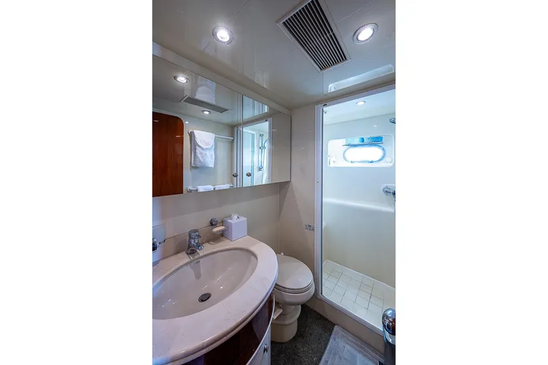 The Usual Yacht Photos Pics Luxurious bathroom on 2000 Horizon 82 yacht with shower, sink, and mirror.
