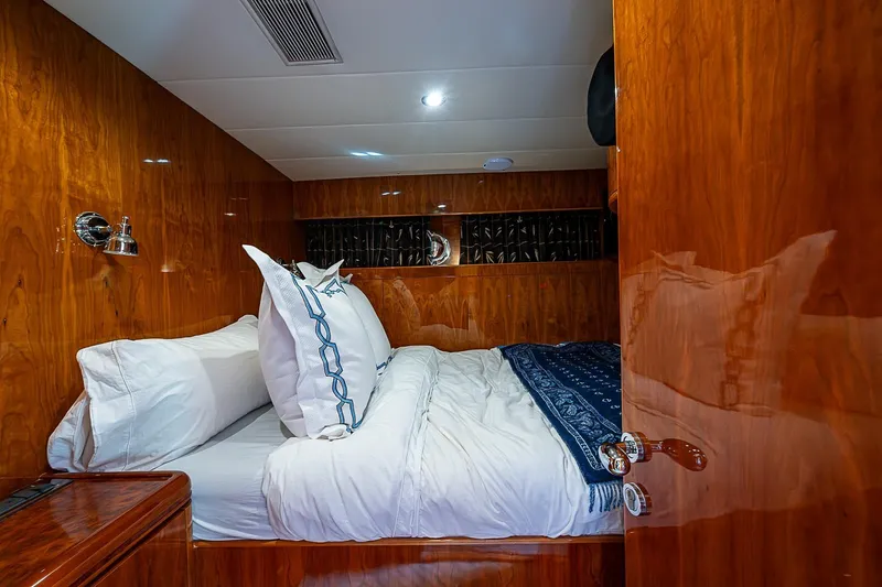 The Usual Yacht Photos Pics Luxurious cabin interior of 2000 Horizon 82 yacht with polished wood and cozy bedding.