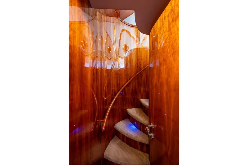 The Usual Yacht Photos Pics Luxurious wooden spiral staircase on a 2000 Horizon 82 yacht interior.