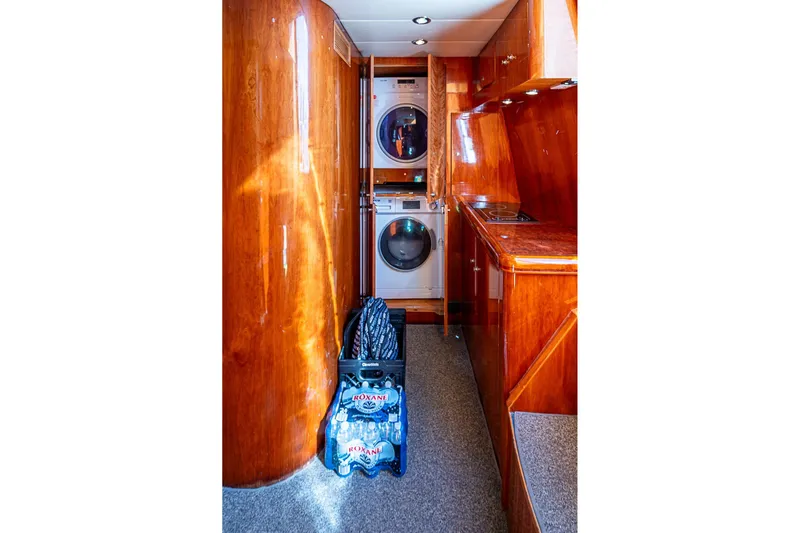 The Usual Yacht Photos Pics Luxurious Horizon 82 yacht interior with wood paneling, washer-dryer, and kitchen area, year 2000.