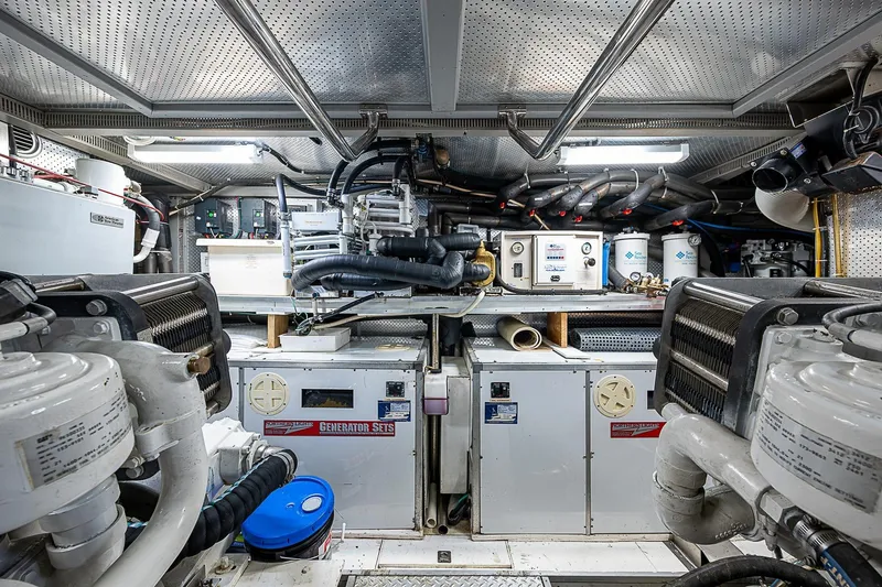 The Usual Yacht Photos Pics Engine room of a 2000 Horizon 82 yacht, featuring generator sets and mechanical equipment.