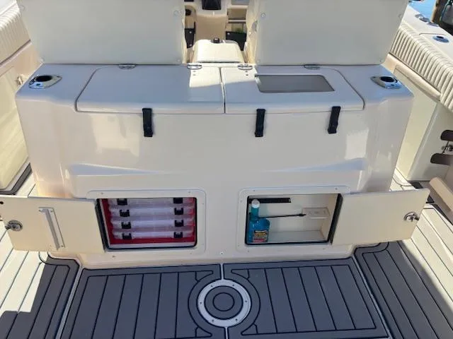 Get Hot Yacht Photos Pics 2011 Grady-White Canyon 306 boat storage compartments and seating area.