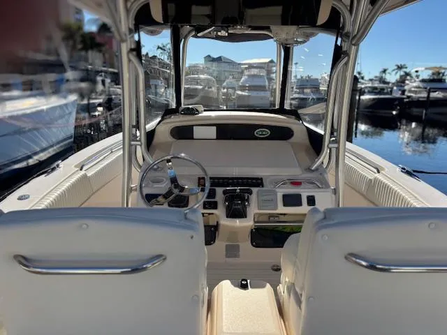 Get Hot Yacht Photos Pics 2011 Grady-White Canyon 306 boat interior with helm and seating, docked at marina.