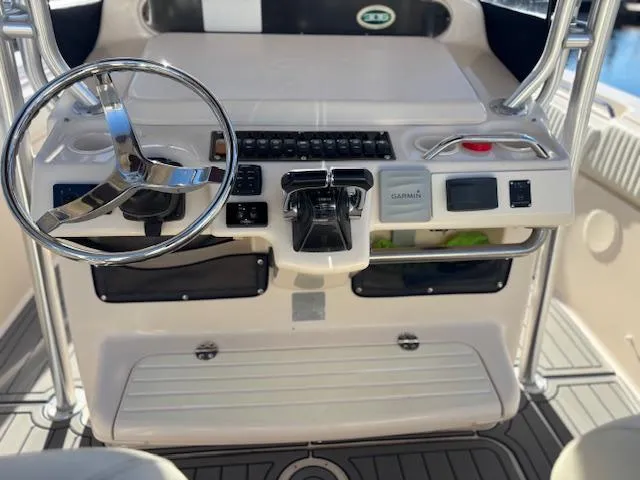 Get Hot Yacht Photos Pics 2011 Grady-White Canyon 306 boat console with steering wheel and controls.