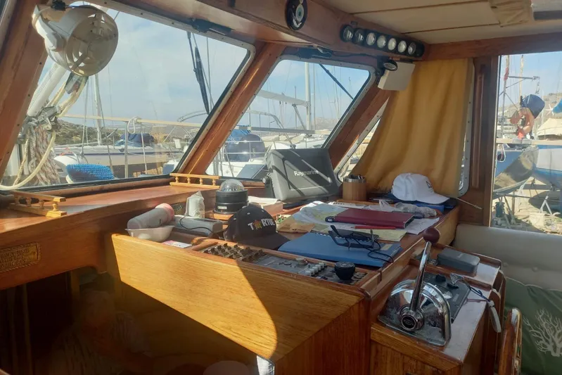  Yacht Photos Pics Interior of a 1994 Siltala Nauticat 38 sailboat with navigation equipment and wooden finish.