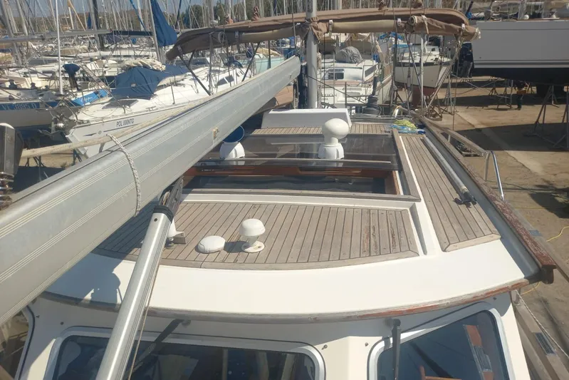  Yacht Photos Pics Siltala Nauticat 38 sailboat from 1994, docked in a marina, showcasing its deck and mast.