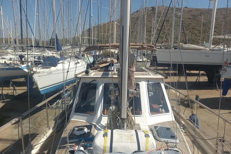  Yacht Photos Pics Siltala Nauticat 38 sailboat from 1994 in a marina, surrounded by other boats.