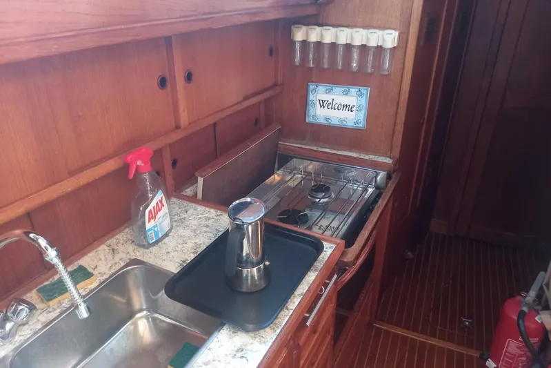  Yacht Photos Pics Cozy galley kitchen in 1994 Siltala Nauticat 38 sailboat with stove and sink.