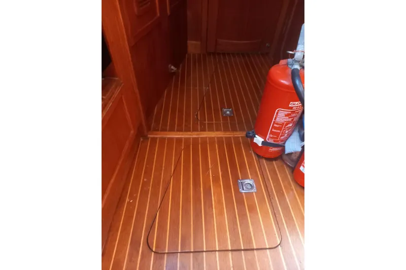  Yacht Photos Pics Interior of 1994 Siltala Nauticat 38 with wooden flooring and fire extinguisher.