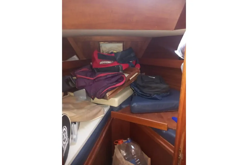  Yacht Photos Pics Cluttered cabin interior of 1994 Siltala Nauticat 38 sailboat with bags and cushions.