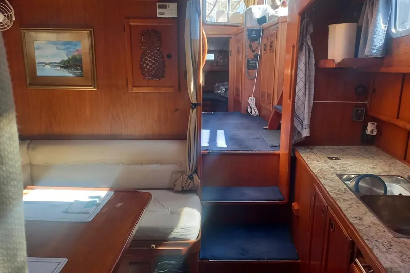  Yacht Photos Pics Interior of 1994 Siltala Nauticat 38 yacht with wooden decor and cozy seating area.