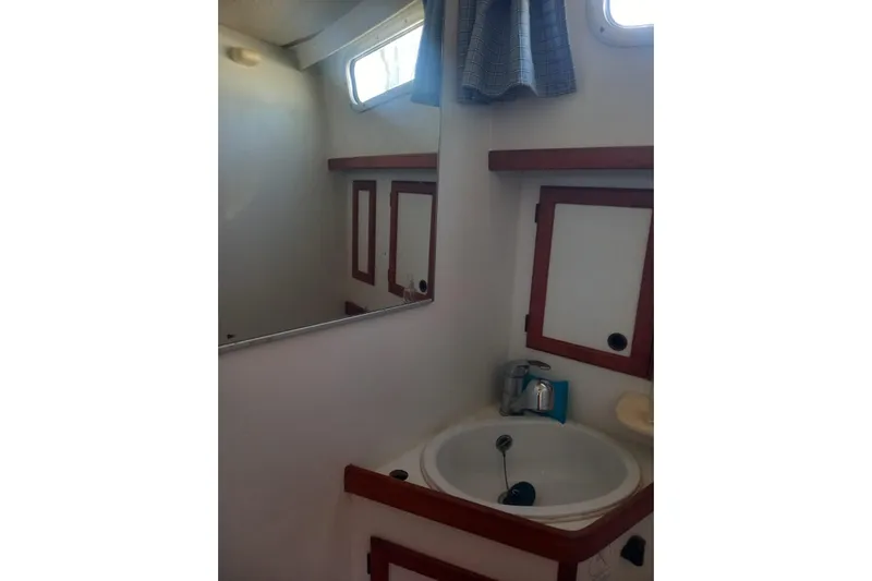  Yacht Photos Pics Bathroom interior of 1994 Siltala Nauticat 38 yacht with sink and mirror.