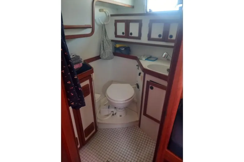  Yacht Photos Pics Bathroom interior of 1994 Siltala Nauticat 38 yacht, featuring compact design and wooden accents.