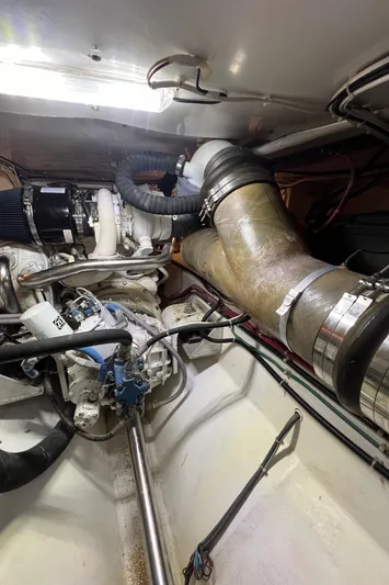 Tomahawk Yacht Photos Pics Engine room of 2011 Flowers Hardtop boat with visible pipes and machinery.