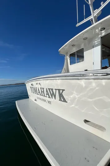 Tomahawk Yacht Photos Pics 2011 Flowers Hardtop boat "Tomahawk" on water under clear blue sky.