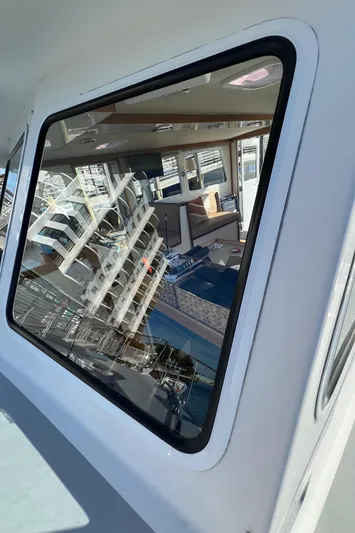 Tomahawk Yacht Photos Pics 2011 Flowers Hardtop boat window reflecting marina and interior view.